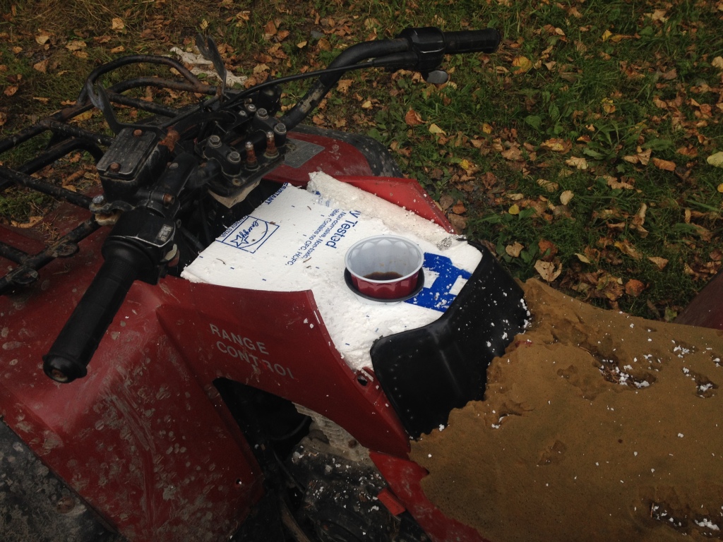Travis adds a thermos holder so he can take coffee on his dog sled runs