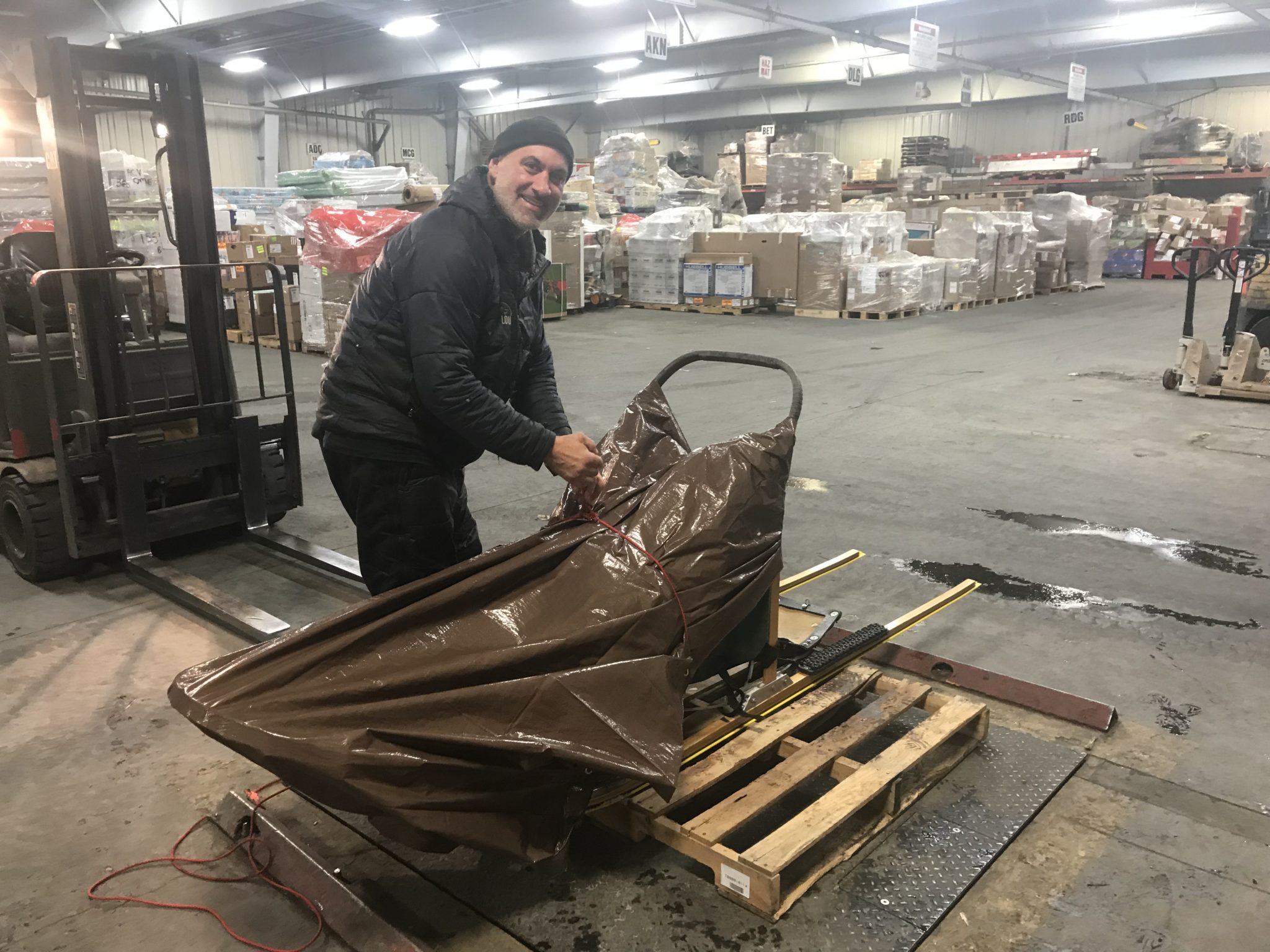 Lou Pereira prepa Travis’ sled for shipment to Unalakleet. Due to the expected forecast, we decided to tarp it.