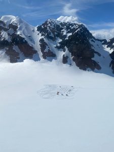 A glacier dog sledding camp in the initial stages of setup.