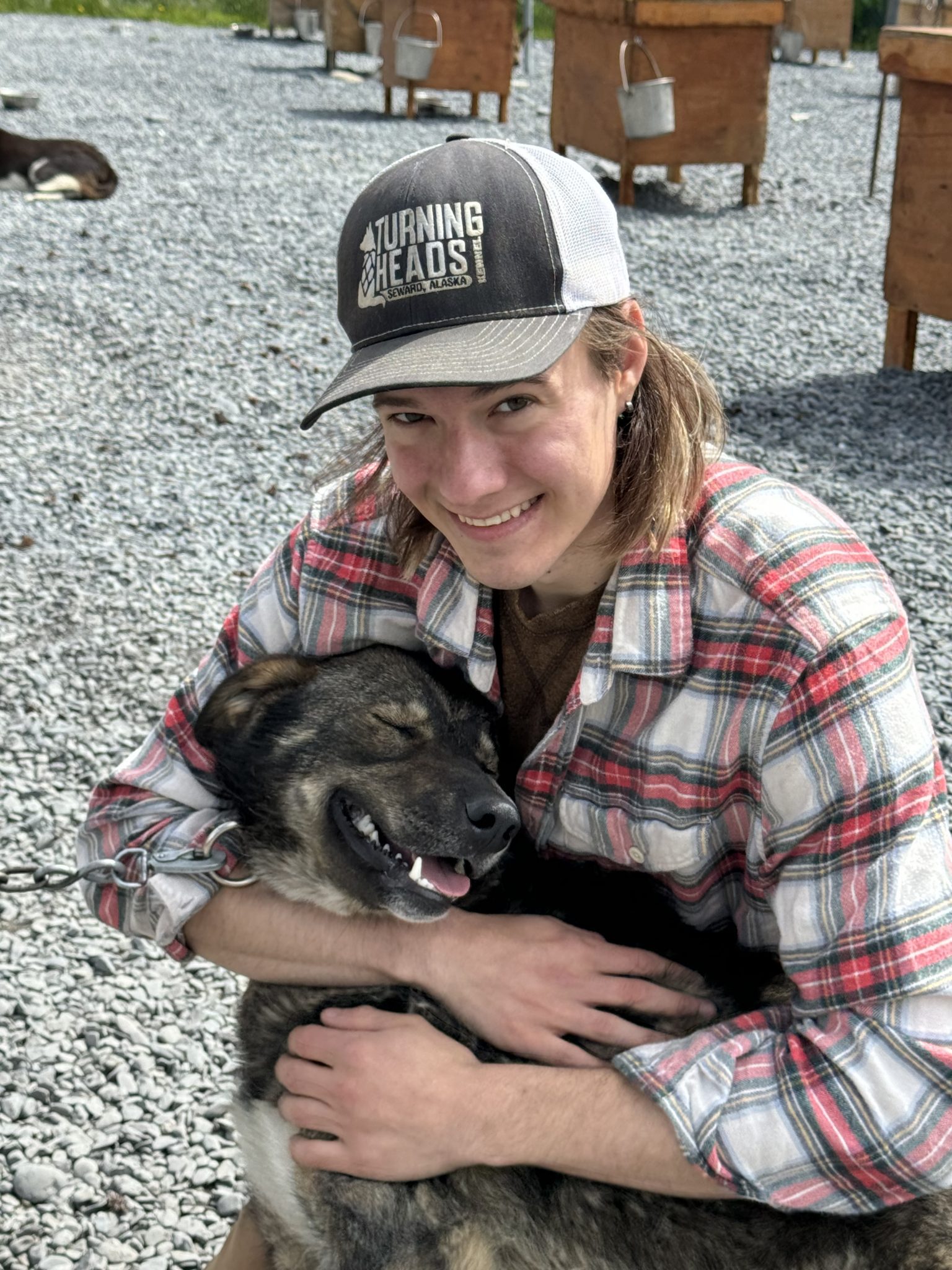 Matt Riese snuggles a Turning Heads Kennel dog on our summer dog sledding adventure